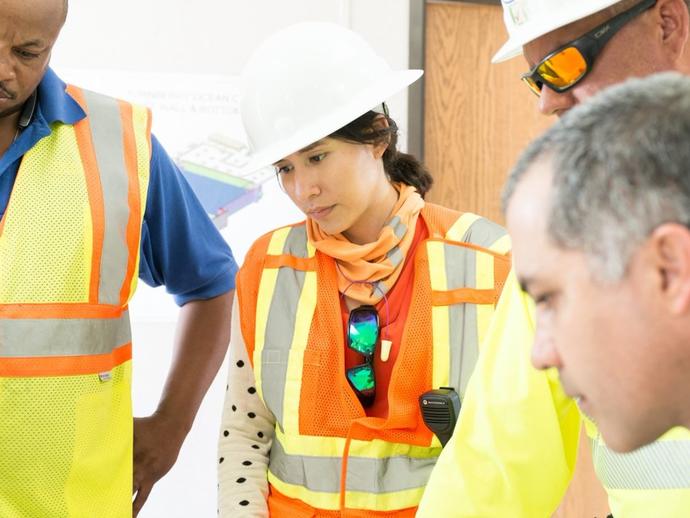 Female Keller project manager talking with colleagues